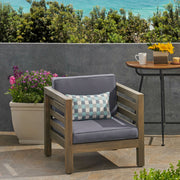 Noble House outdoor acacia wood patio arm chair with fabric cushion, showing a sturdy wooden frame and comfortable seating.