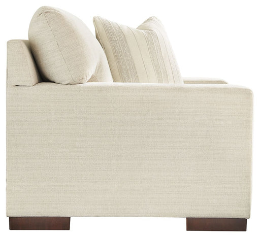 Signature Design by Ashley Maggie chair and a half in neutral fabric, showcasing plush armrests and spacious seating.