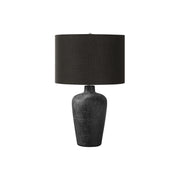 Contemporary black table lamp by 8th Street with a sleek design, featuring a cylindrical base and a fabric lampshade.