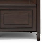 Simpli-Home Connaught storage bench with cushioned top and wooden legs, ideal for entryway or living room storage.