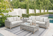 Seton Creek 4-piece gray outdoor lounge set by Signature Design Ashley, includes sofa, chairs, and coffee table for outdoor relaxation.