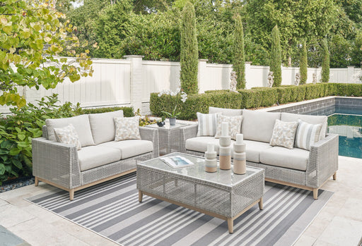 Seton Creek 4-piece gray outdoor lounge set by Signature Design Ashley, includes sofa, chairs, and coffee table for outdoor relaxation.