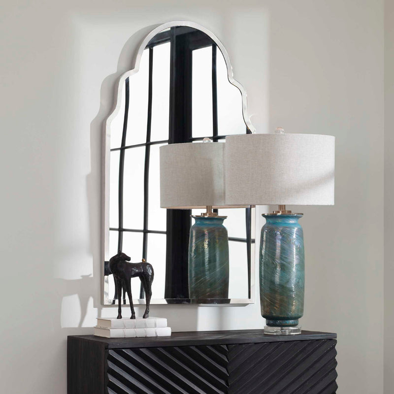 Uttermost Brayden arch wall mirror with nickel finish, featuring a sleek, modern design reflecting light and enhancing room decor.