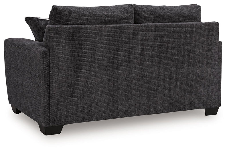 Benchcraft® Loreo stationary loveseat with plush fabric and modern design, shown in a cozy living room setting.