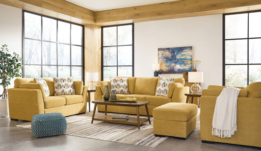 Signature Design by Ashley Keerwick living room set with stationary chair and matching ottoman in neutral fabric.