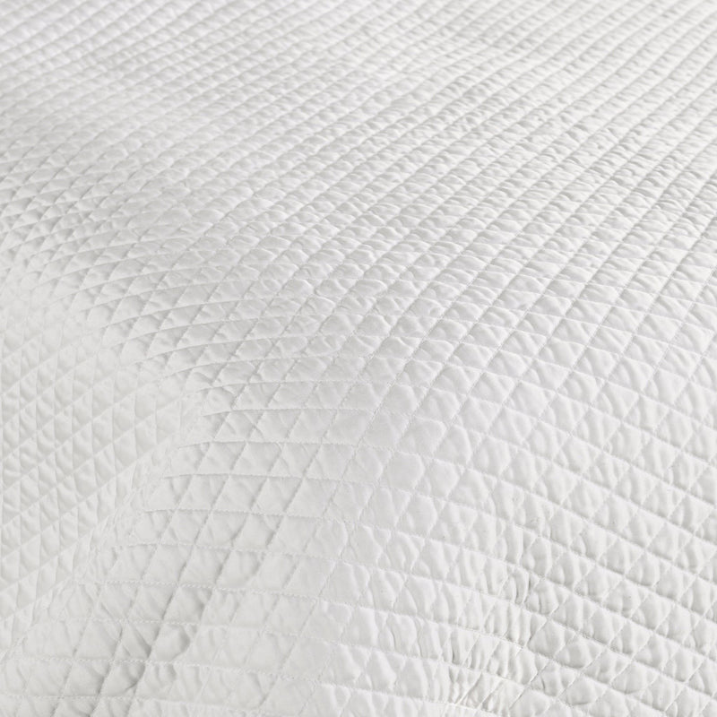 Classic Home diamond quilt with matching shams, featuring a textured pattern and soft fabric for a cozy bedroom look.