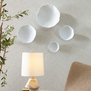Set of four Uttermost Lucky Coins wall decor bowls with intricate designs, mounted on a wall as decorative art pieces.