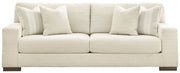 Signature Design by Ashley Maggie stationary sofa with plush cushions and neutral upholstery in a modern living room setting.