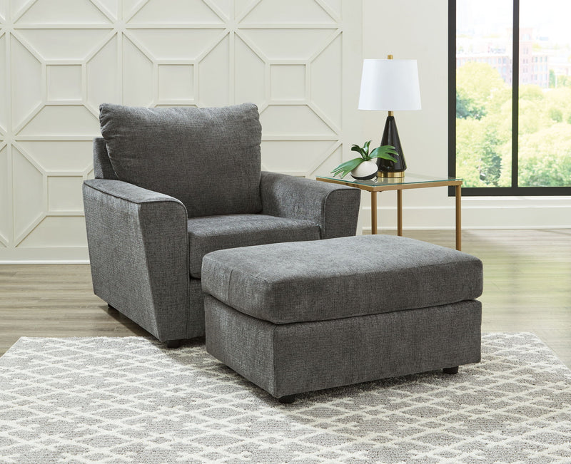Signature Design by Ashley living room set with stationary chair and matching ottoman in a modern, cozy home setting.