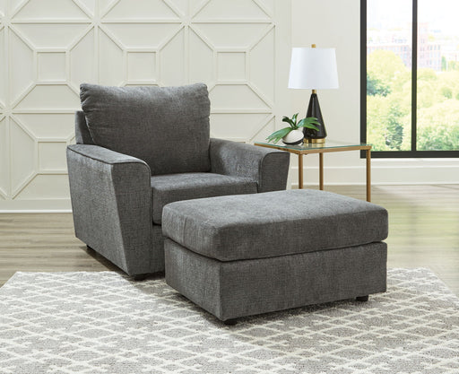 Signature Design by Ashley living room set with stationary chair and matching ottoman in a modern, cozy home setting.