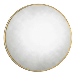 Uttermost Junius round wall mirror with sleek metal frame, hanging on a modern wall, showcasing its contemporary design.