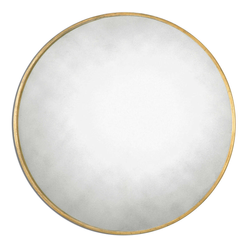 Uttermost Junius round wall mirror with sleek metal frame, hanging on a modern wall, showcasing its contemporary design.