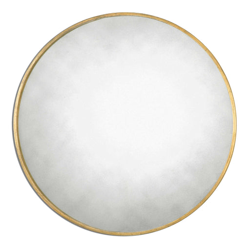 Uttermost Junius round wall mirror with sleek metal frame, hanging on a modern wall, showcasing its contemporary design.