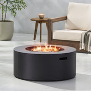 Noble House round iron fire pit with 40,000 Btu for outdoor heating and ambiance, featuring a sturdy circular design.