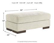 Signature Design by Ashley Maggie upholstered ottoman with soft fabric, featuring a cushioned top and wooden legs for versatile seating.