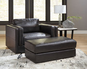 Signature Design by Ashley Amiata living room set with stationary chair and ottoman, featuring plush upholstery and modern design.