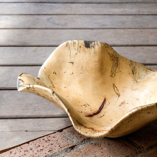 Light brown Tamarine wood bowl by Uttermost, shown as a stylish, handcrafted plate or serving bowl with smooth finish.