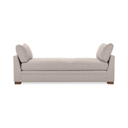 Classic Home Audrey daybed with a wooden frame and neutral upholstery, shown with decorative pillows in a cozy bedroom setting.