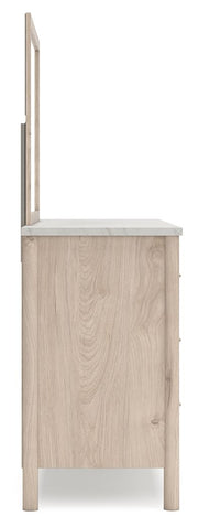 Signature Design by Ashley Cadmori six-drawer dresser with sleek dark wood finish and modern hardware in a bedroom setting.