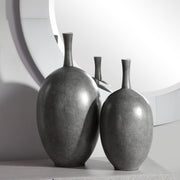 Set of two black Riordan modern vases by Uttermost, featuring sleek cylindrical design and matte finish, ideal for contemporary decor.