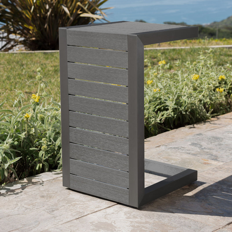 Noble House aluminum outdoor C-shaped side table for patio with sleek, modern design and smooth surface.