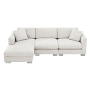 Luxe & Co. modern cloud L-shaped sectional sofa with oversized chaise, four seats, and two free pillows in a stylish living room setting.