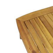 Noble House outdoor acacia wood loveseat set with two cushioned seats and a matching coffee table in a garden setting.
