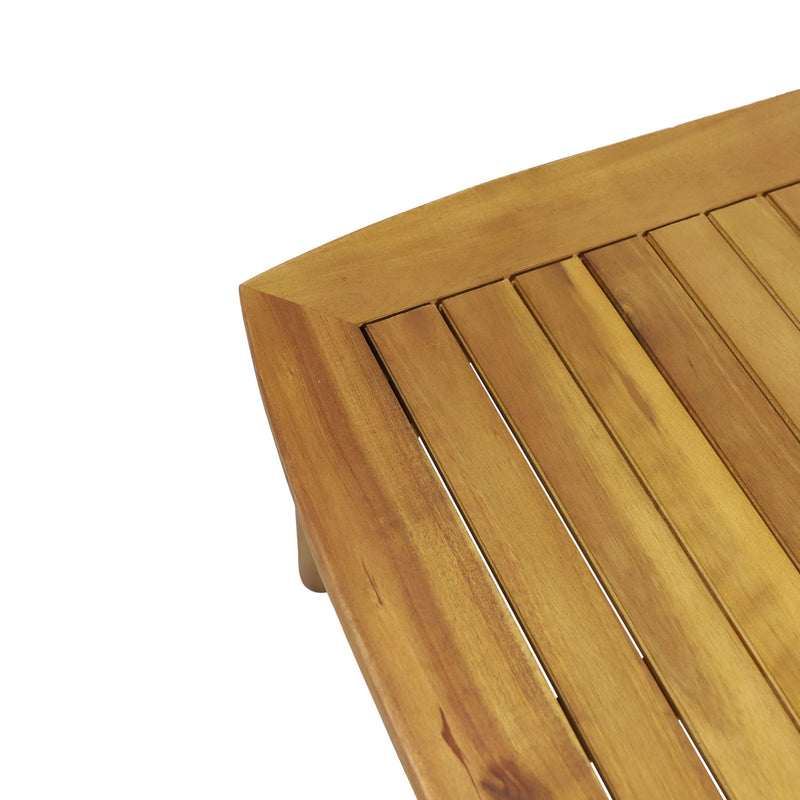 Noble House outdoor acacia wood loveseat set with two cushioned seats and a matching coffee table in a garden setting.