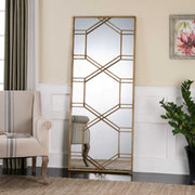 Uttermost Kennis Leaf Leaner Mirror with gold finish, decorative leaf design, tall rectangular shape, leaning against a wall.