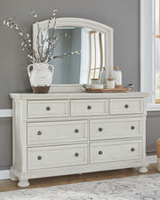 Ashley Robbinsdale Sleigh 6-piece bedroom set with a sleigh bed, dresser, mirror, and matching nightstands in a modern wood finish.