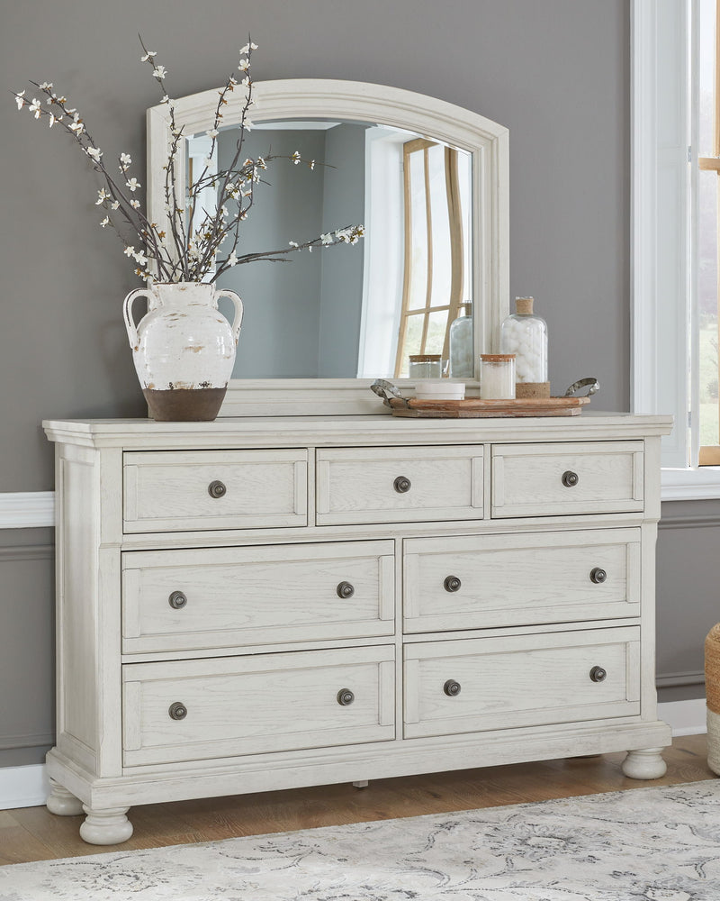 Ashley Robbinsdale Sleigh 6-piece bedroom set with a sleigh bed, dresser, mirror, and matching nightstands in a modern wood finish.