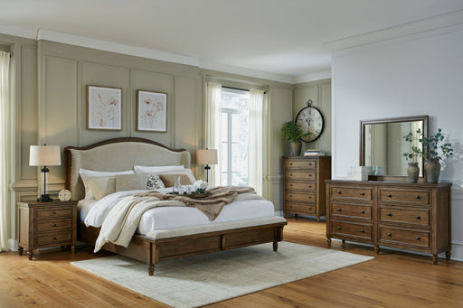 Benchcraft Sturlayne 6-piece panel bedroom set with matching bed frame, dresser, and nightstands in a modern bedroom design.