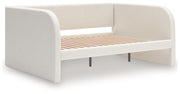 Upholstered Signature Design by Ashley® Arloster day bed with plush fabric and wooden legs, stylish and comfortable for any bedroom.
