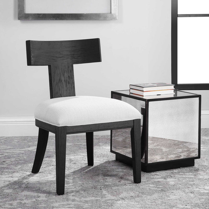 Uttermost Idris armless side chair with plush upholstered seat and sleek wooden legs, modern design for stylish seating.