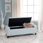 Noble House Guernsey storage ottoman with tufted top, beige fabric, and wooden legs, serving as a stylish storage solution.