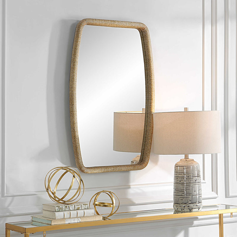 Uttermost gold Tiki accent mirror with a tropical-inspired design, featuring a textured tiki figure in a gold finish.
