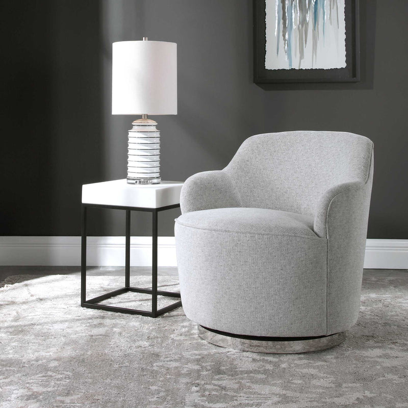 Uttermost Hobart gray casual swivel chair with padded seat and backrest, featuring a modern design and wooden base.