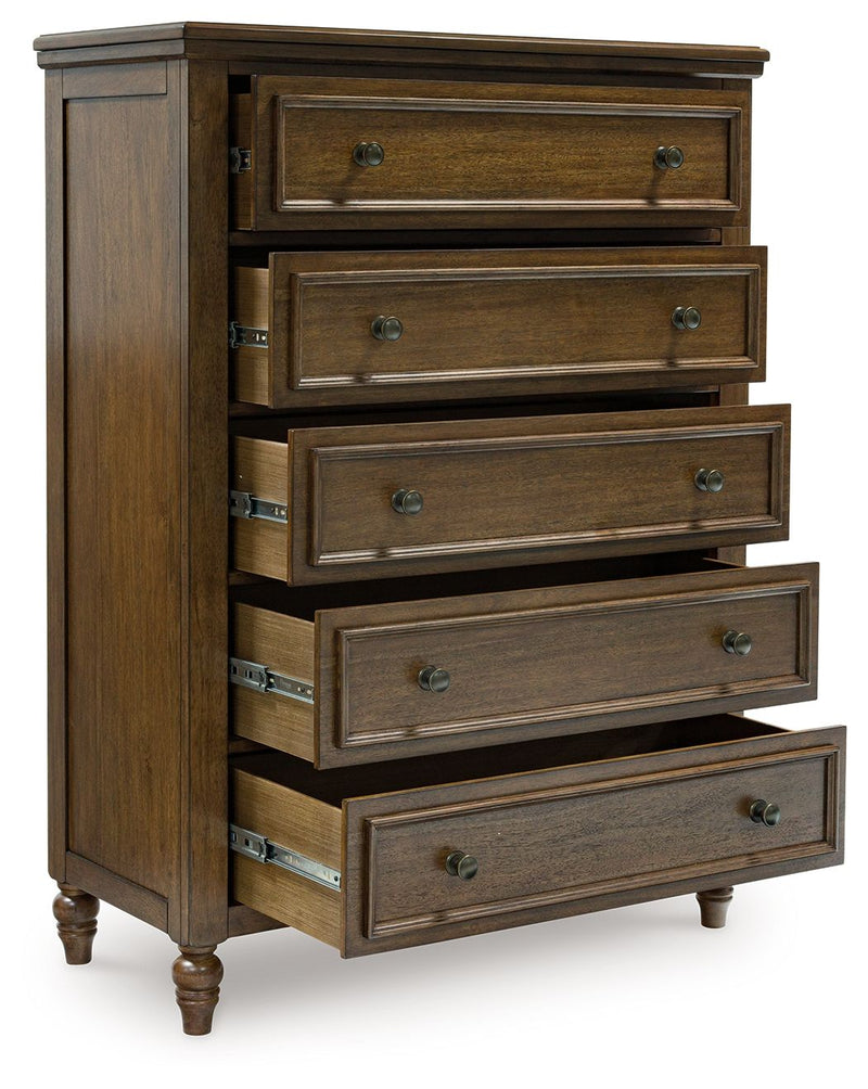Benchcraft® Sturlayne 6-piece panel bedroom set including bed frame, dresser, mirror, nightstands, and chest in a modern bedroom.