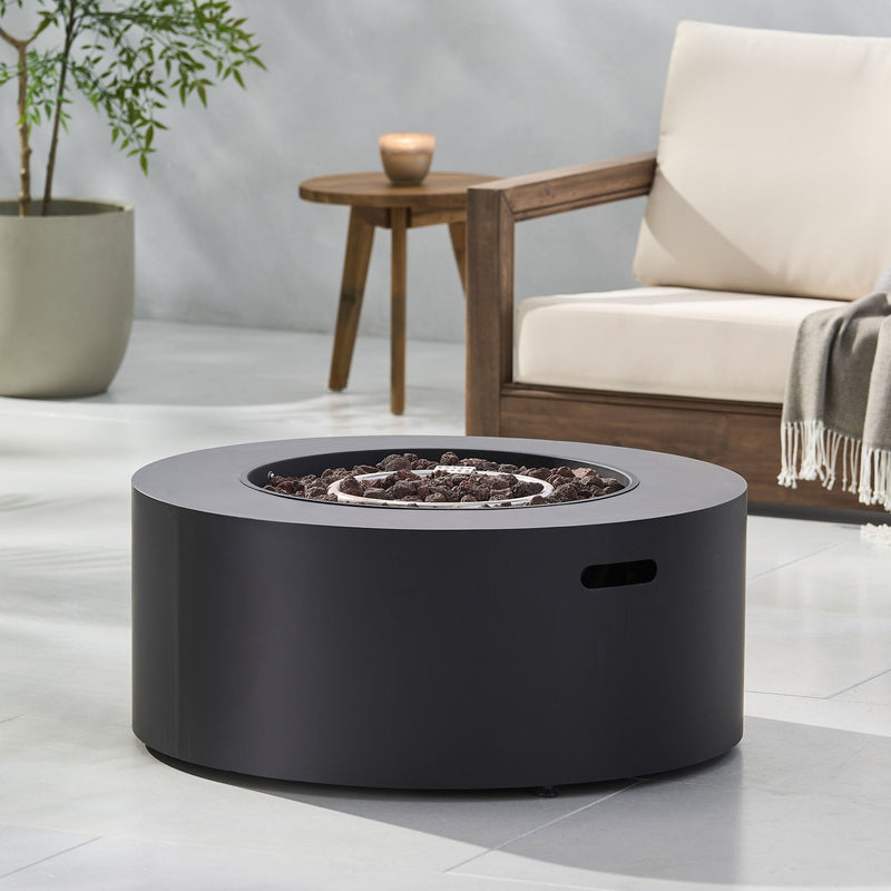 Round iron fire pit by Noble House with 40,000 Btu, featuring a sturdy metal construction and a decorative design for outdoor warmth