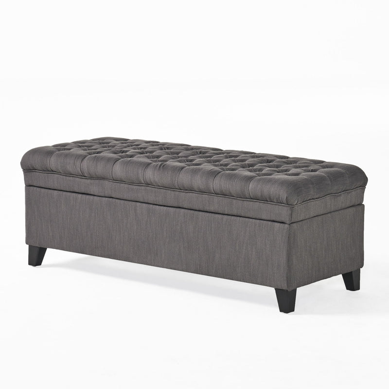 Juliana storage ottoman by Noble House with birch wood legs, upholstered in soft fabric, showing a cushioned top and interior storage space.