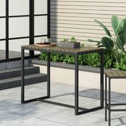Outdoor industrial-style Noble House Ernesto bar table made of acacia wood, featuring a sturdy rectangular design for outdoor use.