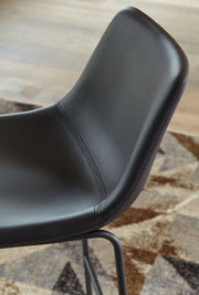 Set of two Signature Design by Ashley® Centiar upholstered barstools with cushioned seats and sleek wooden legs.