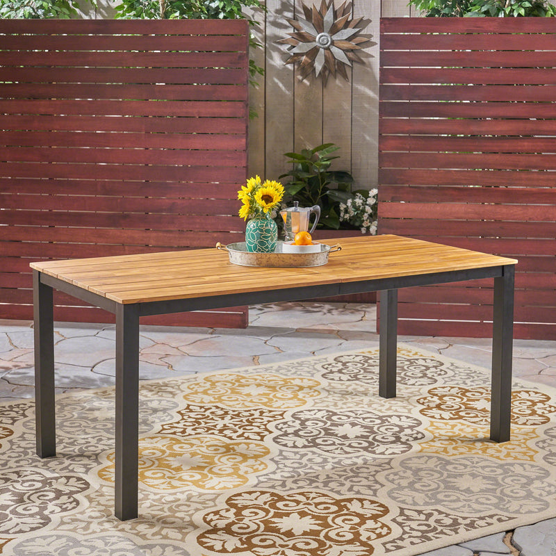 Black rectangular outdoor dining table with iron legs, Noble House dining table with smooth tabletop and sturdy metal frame.
