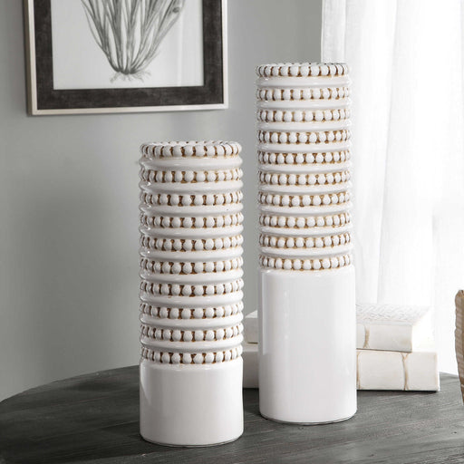 Pair of white Uttermost Angelou vases, set of 2, featuring sleek, modern ceramic design for stylish home decor.