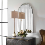 Uttermost Brayden frameless arched wall mirror with pearl silver finish reflecting a modern, elegant bathroom interior.