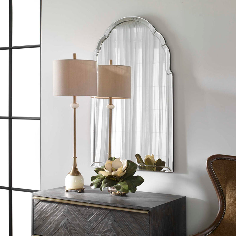 Uttermost Brayden frameless arched wall mirror with pearl silver finish reflecting a modern, elegant bathroom interior.