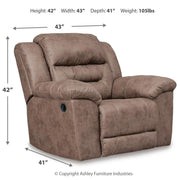 Signature Design by Ashley Stoneland rocker recliner with plush upholstery and wooden base, shown in a cozy living room setting.