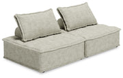 Signature Design by Ashley stationary sectional sofa with plush cushions and fabric upholstery, shown in a modern living room setting.