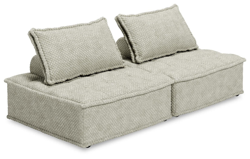 Signature Design by Ashley stationary sectional sofa with plush cushions and fabric upholstery, shown in a modern living room setting.