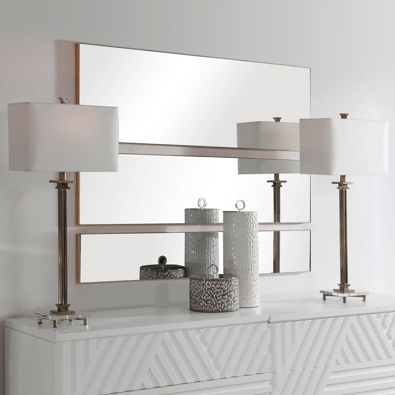Set of three gold wall mirrors by Uttermost, featuring round and oval shapes with decorative gold frames for stylish wall decor.
